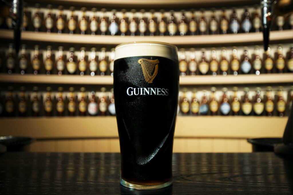 A settled pint of Guinness with a thick creamy head standing on a Dublin bar counter