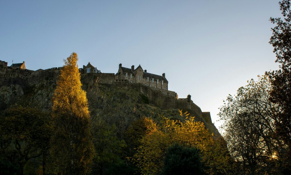 Edinburgh Castle above trees in autumn colours