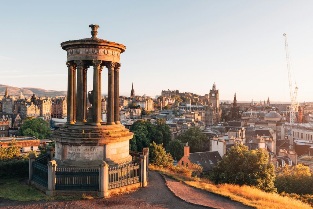 Edinburgh seen from Calton Hill at sunset, with the Old Town skyline in the distance
