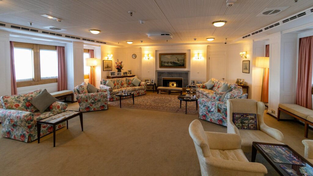 A sitting room with a fireplace aboard the Royal Yacht Britannia in Leith, Edinburgh