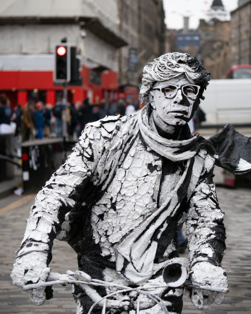 A street performer entertaining a crowd on the Royal Mile during the Edinburgh Fringe