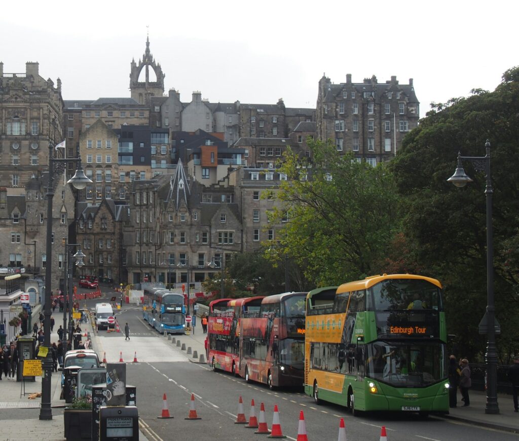 Open-top sightseeing buses parked in Edinburgh's Old Town