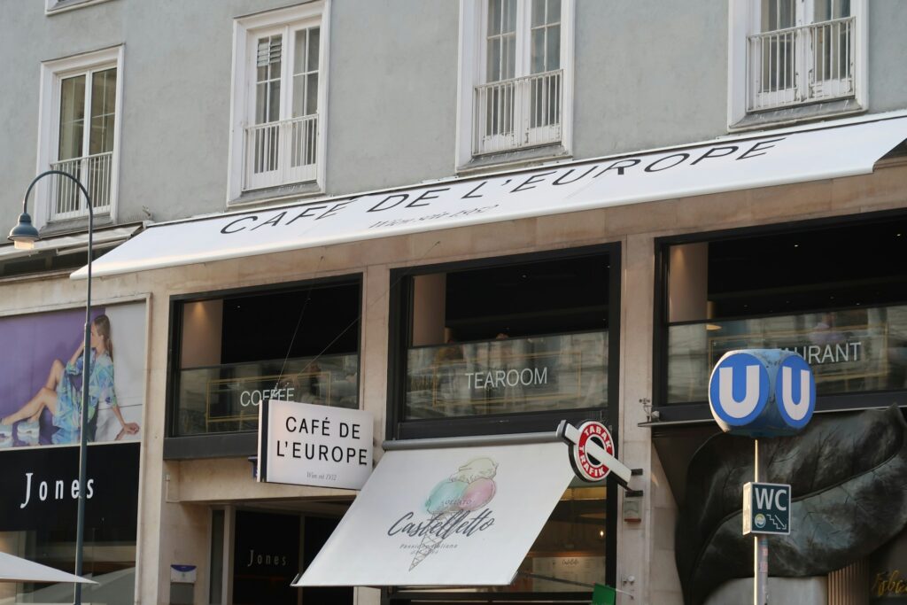 Café facade in central Vienna with a metro sign beside it