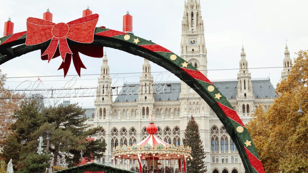 Christmas market arch and carousel in front of Vienna City Hall by day