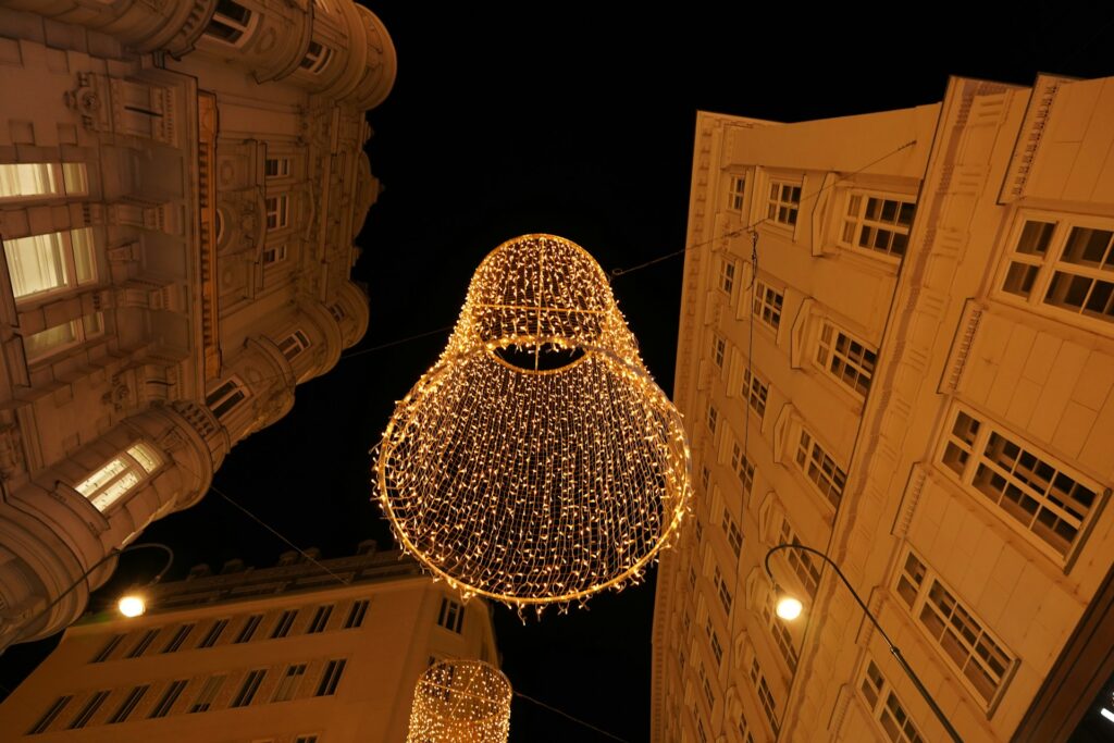 Golden Christmas lights strung above a Vienna street