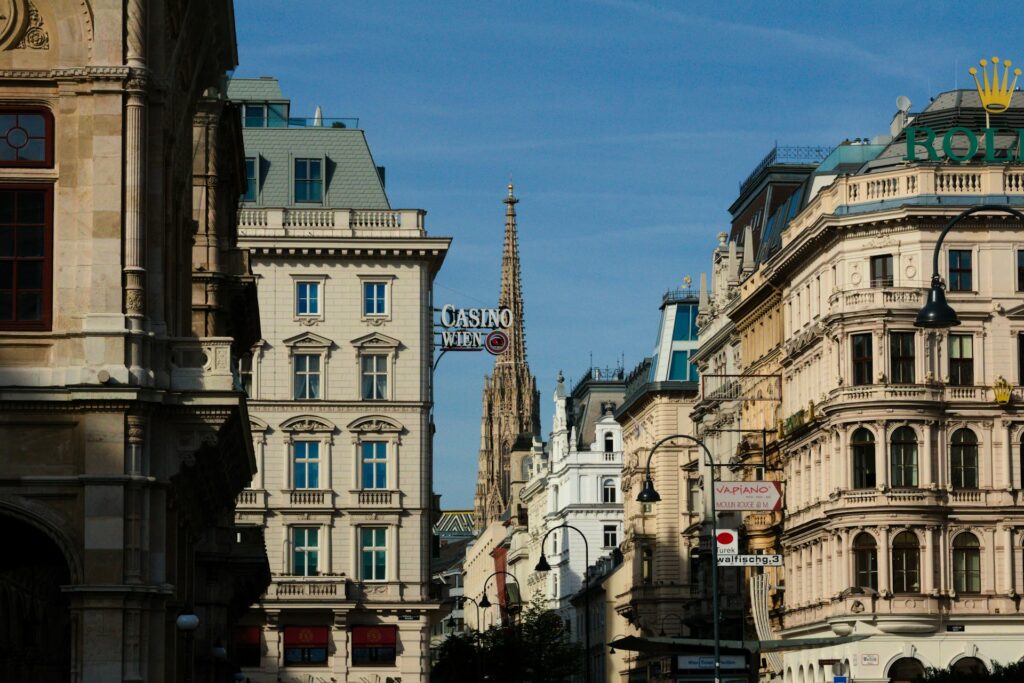 A street in Vienna's old town with the spire of St Stephen's Cathedral behind the rooftops