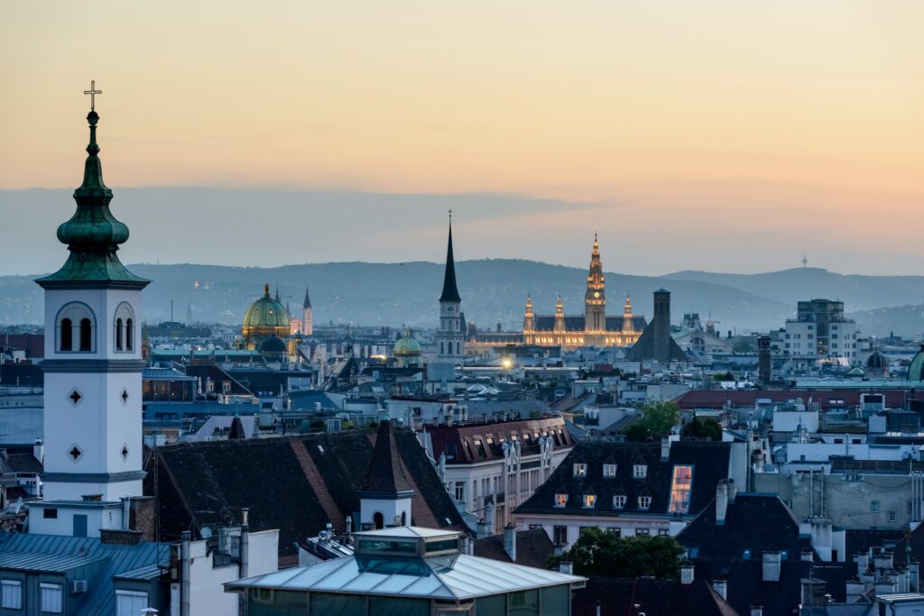 Vienna rooftops, church towers and the City Hall at sunset