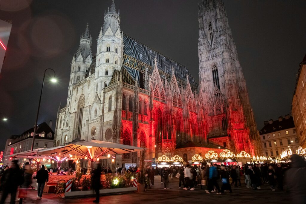 St Stephen's Cathedral lit in red above the Christmas market at Stephansplatz