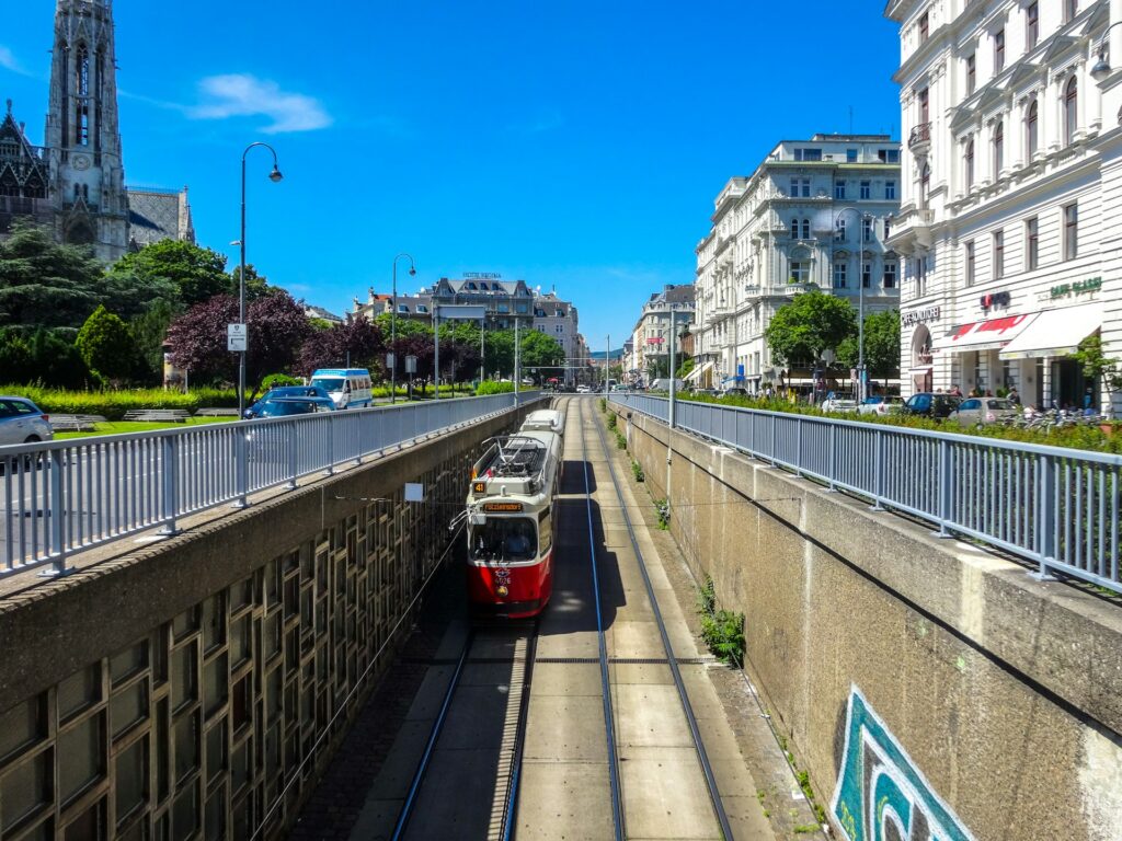 A tram passing below the twin spires of the Votivkirche near Schottentor in Vienna